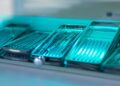 Rows of stacked trays full of reusable medical devices. They are inside the chamber of a sterilization machine.